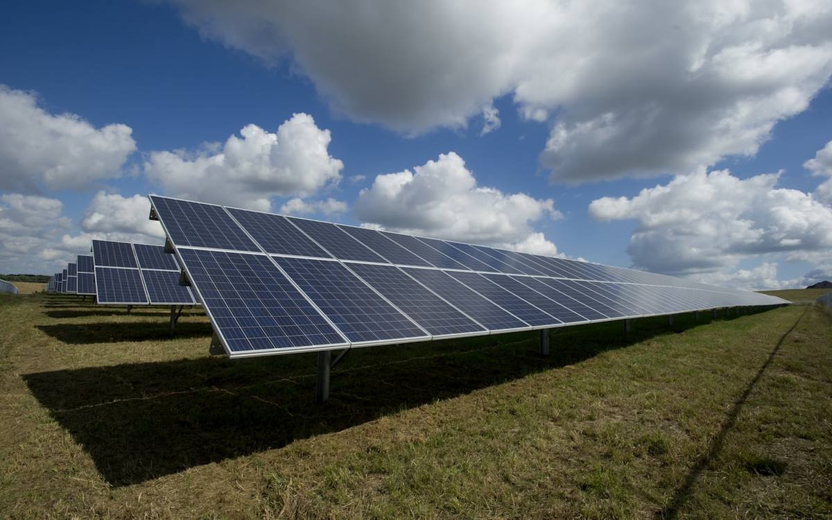 Solar array under open sky representing sustainability and environmental solutions